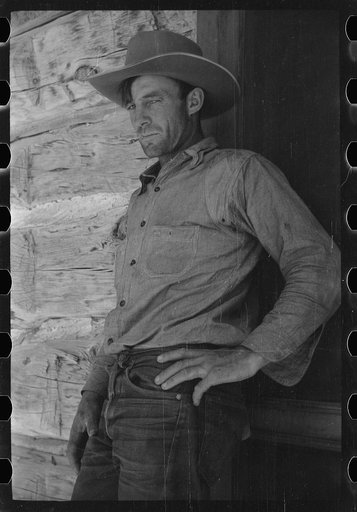 Untitled photo, possibly related to: Cowboy in front of bunkhouse, Quarter Circle U Ranch, Big Horn County, Montana