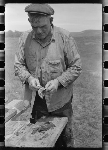 Untitled photo, possibly related to: Sheepshearer cleans blade of his shears, Rosebud County, Montana