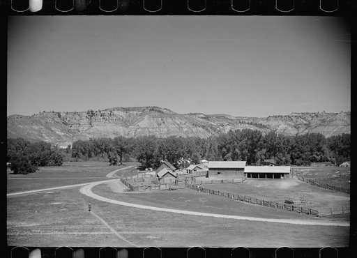 Untitled photo, possibly related to: Jack Arnold looking over the Quarter Circle U Ranch which he owns, Rosebud County, Montana