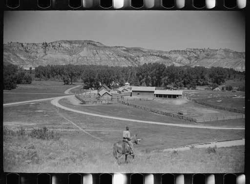 Untitled photo, possibly related to: Jack Arnold looking over the Quarter Circle U Ranch which he owns, Rosebud County, Montana