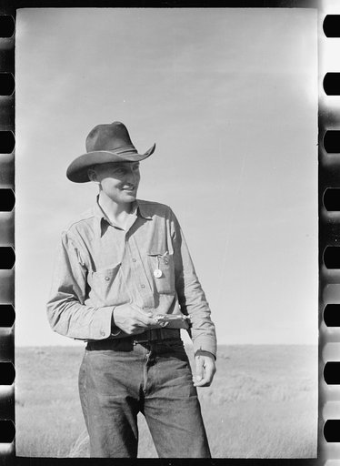 Cowboy with syringe used in immunization against blackleg, Quarter Circle U roundup, Montana