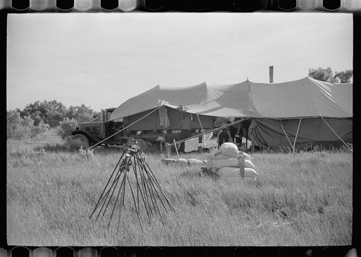 Branding irons in front of roundup tent, Quarter Circle U roundup, Montana