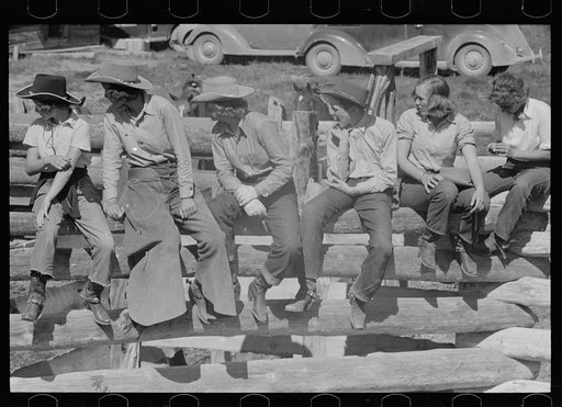 Dude girls on a corral fence, Quarter Circle U roundup, Montana