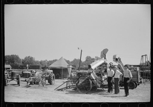 Untitled photo, possibly related to: Farmer inspects a cultivator, Central Iowa 4-H Club fair, Marshalltown, Iowa
