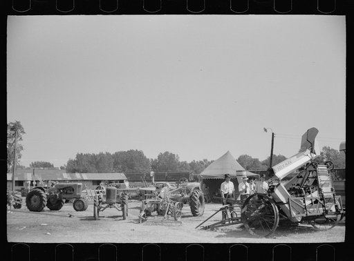 Untitled photo, possibly related to: Farmer inspects a cultivator, Central Iowa 4-H Club fair, Marshalltown, Iowa