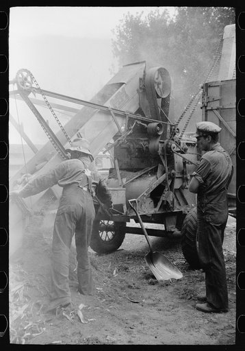 Untitled photo, possibly related to: Fixing a corn shelling machine, Grundy County, Iowa