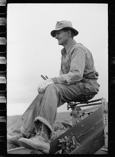 Untitled photo, possibly related to: Farmer on one-row potato digger, Rio Grande County, Colorado
