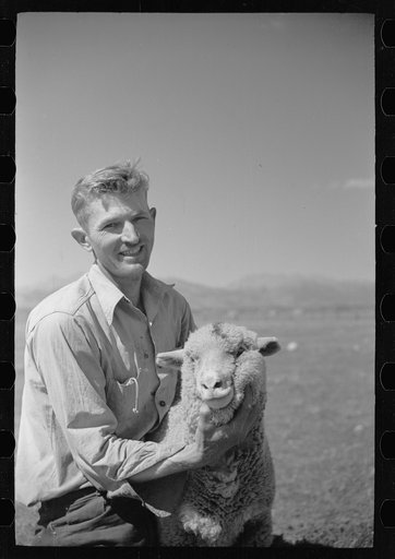 Elmo Temple, Chaffee County, Colorado rehabilitation client poses with one of his lambs