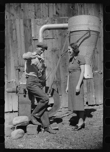 Elmo Temple, Chaffee County, Colorado rehabilitation client and his wife, Louise, pose beside a feed grinder which is an important part of their farm equipment