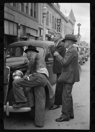 Men watching World Series baseball scores on main street, Montrose, Colorado