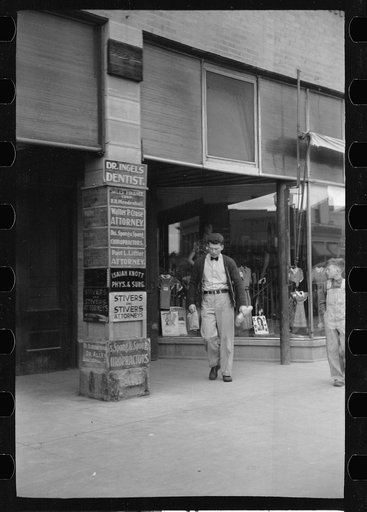 Untitled photo, possibly related to: Newsboy on main street, Montrose, Colorado
