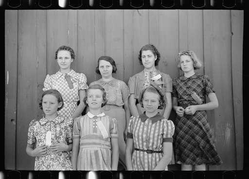 Daughters of resettlement clients who have formed 4-H Club and won fair prizes posed with their leader, Mrs. Lucky (second from left), Western Slope Farms, Colorado
