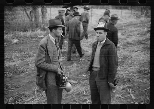 Photographer and editor of local paper at cornhusking contest, Marshall County, Iowa