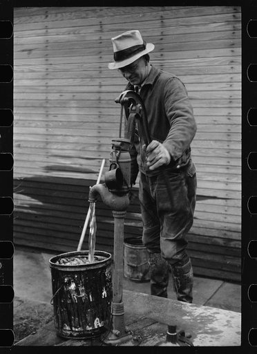 Farmer pumping water, Parke County, Indiana