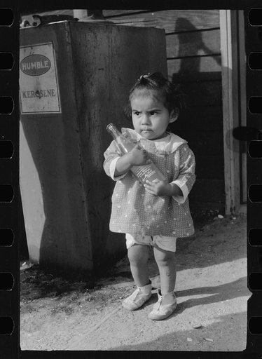 Migratory worker's child at community store, FSA (Farm Security Administration) camp, Sinton, Texas