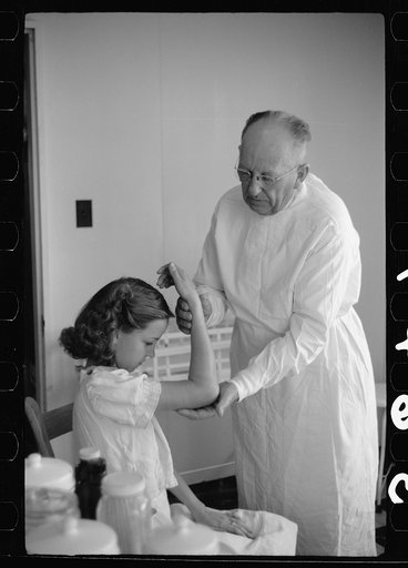 Untitled photo, possibly related to: Doctor examines fractured arm, FSA (Farm Security Administration) camp clinic, Weslaco, Texas