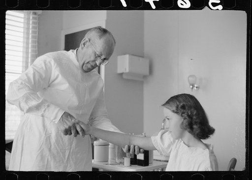 Untitled photo, possibly related to: Doctor examines fractured arm, FSA (Farm Security Administration) camp clinic, Weslaco, Texas