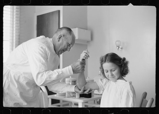 Untitled photo, possibly related to: Doctor examines fractured arm, FSA (Farm Security Administration) camp clinic, Weslaco, Texas