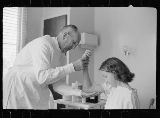 Untitled photo, possibly related to: Doctor examines fractured arm, FSA (Farm Security Administration) camp clinic, Weslaco, Texas