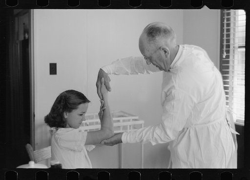 Untitled photo, possibly related to: Doctor examines fractured arm, FSA (Farm Security Administration) camp clinic, Weslaco, Texas
