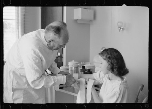 Untitled photo, possibly related to: Doctor examines fractured arm, FSA (Farm Security Administration) camp clinic, Weslaco, Texas