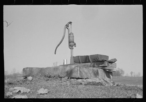 Pump, oilcan cut in half used as trough, Nashville, Brown County, Indiana