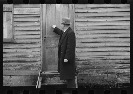 Resettlement Administration representative at door of rehabilitation client's house, Jackson County, Ohio