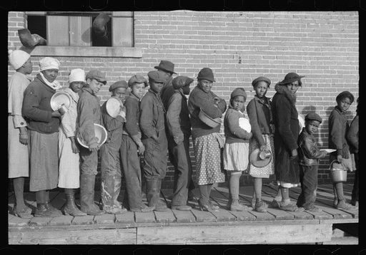 Untitled photo, possibly related to: Lined up and waiting for a meal in the camp for Negro flood refugees at Forrest City, Arkansas