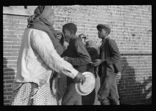 Untitled photo, possibly related to: Lined up and waiting for a meal in the camp for Negro flood refugees at Forrest City, Arkansas