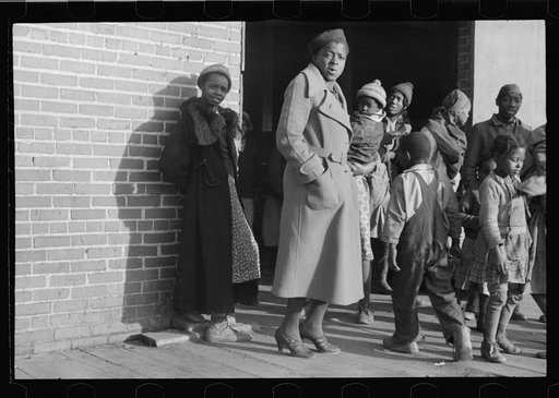 Untitled photo, possibly related to: Lined up and waiting for a meal in the camp for Negro flood refugees at Forrest City, Arkansas