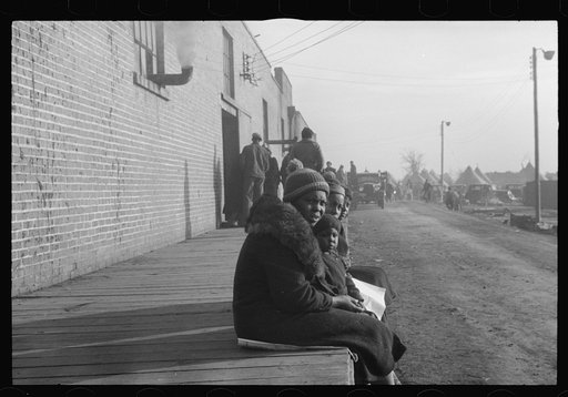 Untitled photo, possibly related to: Lined up and waiting for a meal in the camp for Negro flood refugees at Forrest City, Arkansas