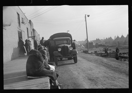 Untitled photo, possibly related to: Lined up and waiting for a meal in the camp for Negro flood refugees at Forrest City, Arkansas