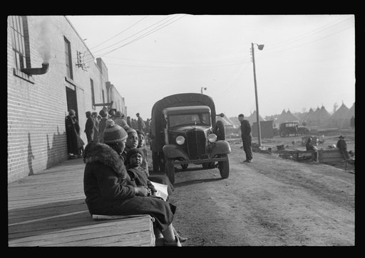 Untitled photo, possibly related to: Lined up and waiting for a meal in the camp for Negro flood refugees at Forrest City, Arkansas