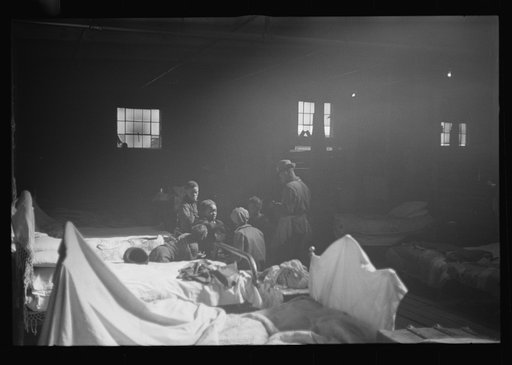 Untitled photo, possibly related to: Interior of cotton compress at Forrest City, Arkansas where sick Negro refugees from flood of 1937 are housed