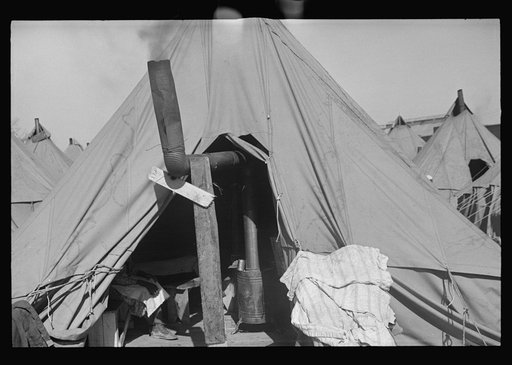 Untitled photo, possibly related to: A Negro flood refugee family who, with their rescued household goods have moved into the camp at Forrest City, Arkansas