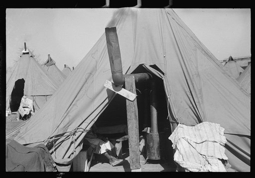 Untitled photo, possibly related to: A Negro flood refugee family who, with their rescued household goods have moved into the camp at Forrest City, Arkansas