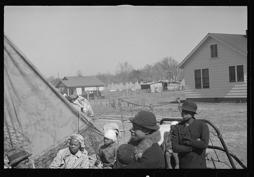 Untitled photo, possibly related to: A Negro flood refugee family who, with their rescued household goods have moved into the camp at Forrest City, Arkansas