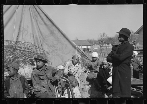 Untitled photo, possibly related to: A Negro flood refugee family who, with their rescued household goods have moved into the camp at Forrest City, Arkansas