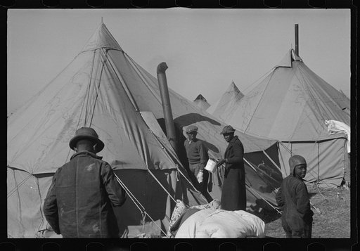 Untitled photo, possibly related to: A Negro flood refugee family who, with their rescued household goods have moved into the camp at Forrest City, Arkansas