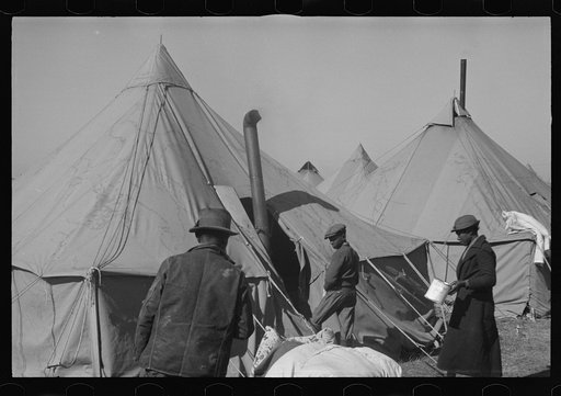 Untitled photo, possibly related to: A Negro flood refugee family who, with their rescued household goods have moved into the camp at Forrest City, Arkansas