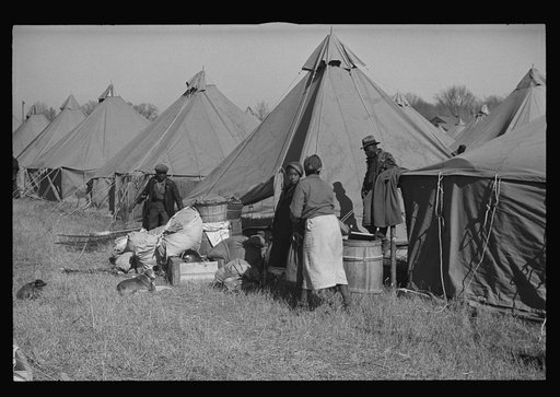 A Negro flood refugee family who, with their rescued household goods have moved into the camp at Forrest City, Arkansas