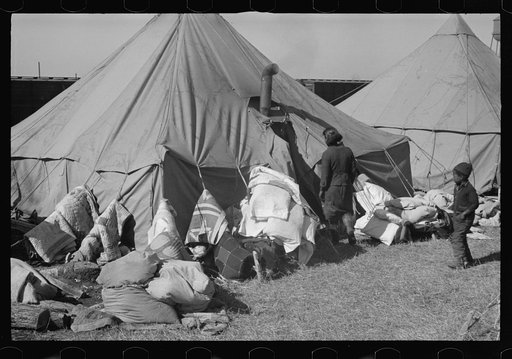 Untitled photo, possibly related to: A Negro flood refugee family who, with their rescued household goods have moved into the camp at Forrest City, Arkansas