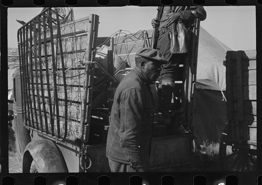 Untitled photo, possibly related to: A Negro flood refugee family who, with their rescued household goods have moved into the camp at Forrest City, Arkansas