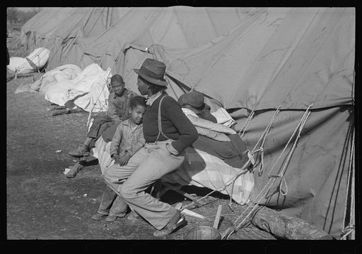 Untitled photo, possibly related to: A Negro flood refugee family who, with their rescued household goods have moved into the camp at Forrest City, Arkansas