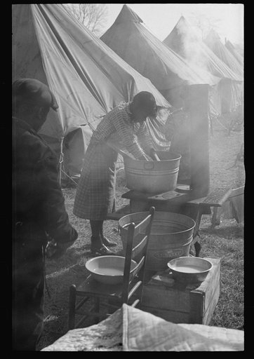 Untitled photo, possibly related to: Negro flood refugee washing clothes in the camp at Forrest City, Arkansas