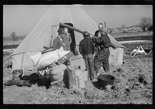 A family of flood refugees and their salvaged household goods in the camp at Forrest City