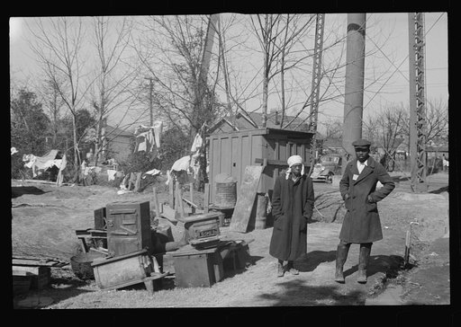 Untitled photo, possibly related to: A family of flood refugees and their salvaged household goods in the camp at Forrest City