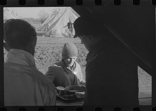 An old lady at mealtime in the camp for white refugees from the flood of 1937, Forrest City, Arkansas