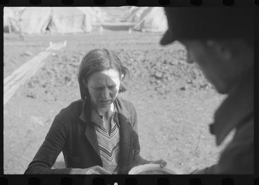 Woman at mealtime in the camp for white flood refugees, Forrest City, Arkansas