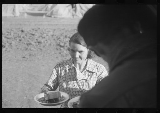 Untitled photo, possibly related to: Woman at mealtime in the camp for white flood refugees, Forrest City, Arkansas